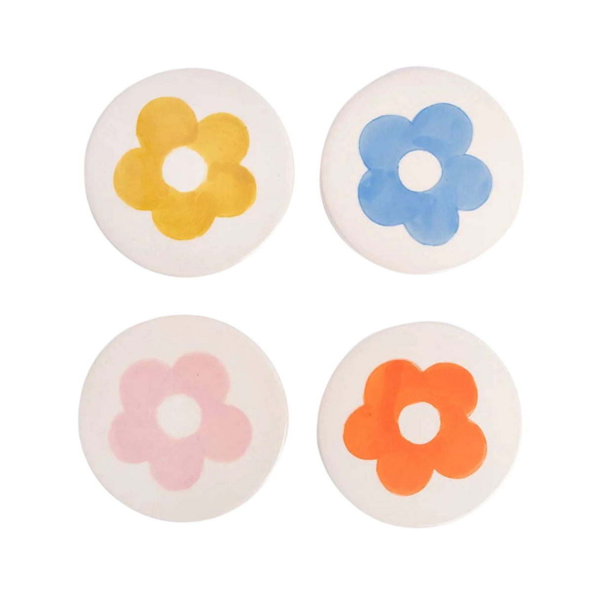 Four round coasters with colorful flower designs on a white background