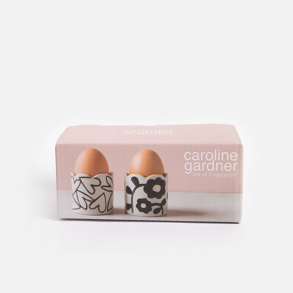 Set of two floral-patterned egg cups in a pink box with 'caroline gardner' branding.