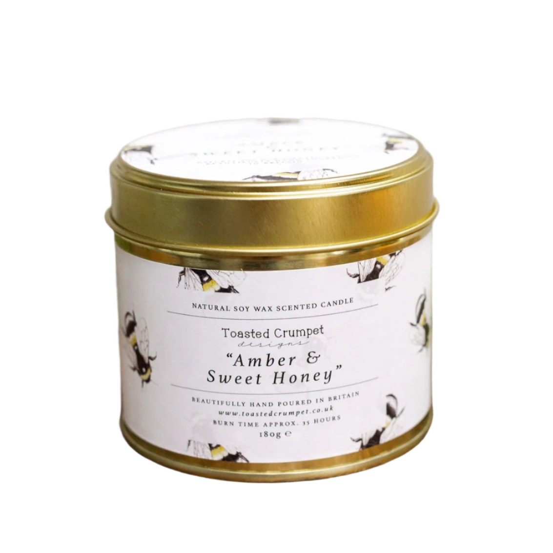 Scented candle in a tin with a gold lid on a white background