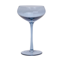 Blue textured cocktail glass on a white background