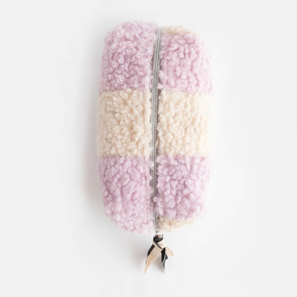 Pastel-colored fluffy pouch with a zipper on a white background