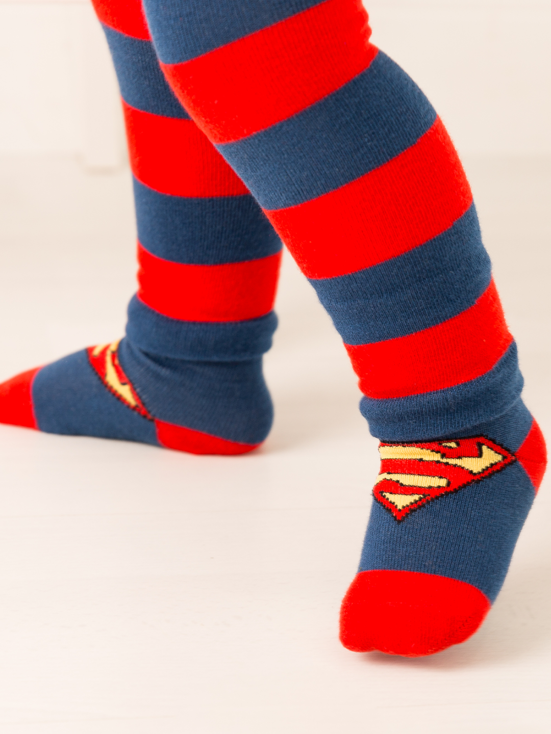 Red and blue striped socks with Superman logo on a white background